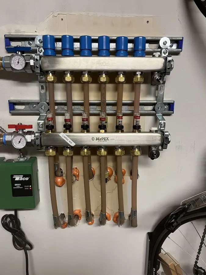 Plumber performing Water Heater Repair at a residential property in Troy